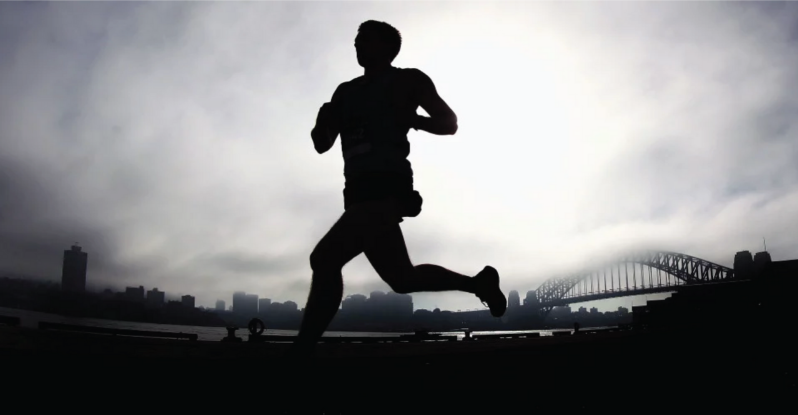 Runner with cityscape background representing performance – XLR8 Nutrition